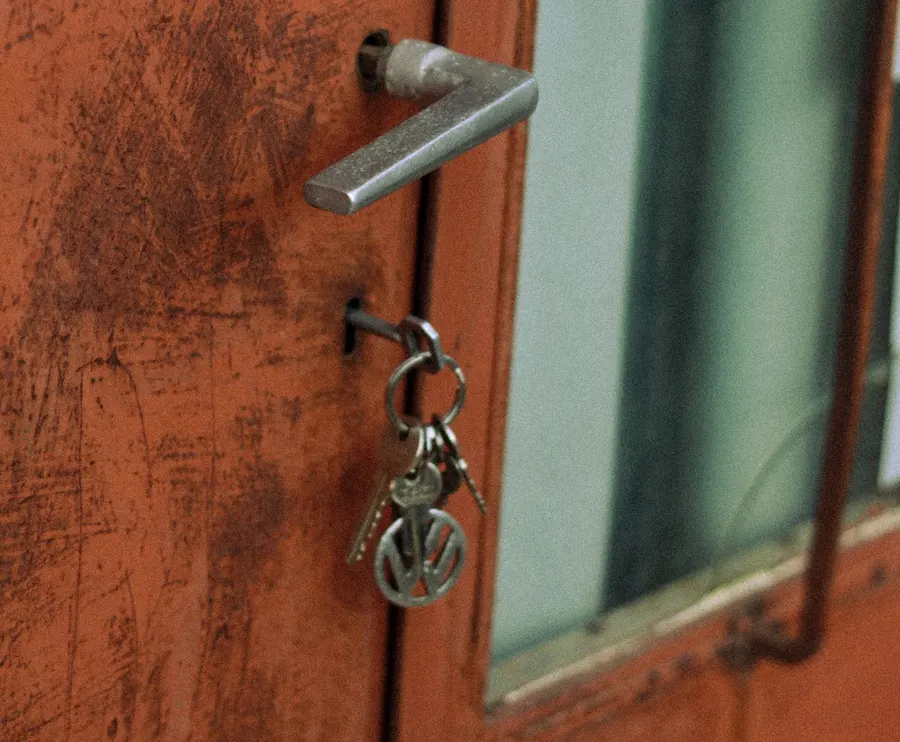Keys hanging from the lock of an old door